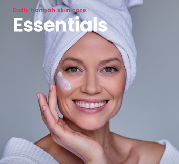 Smiling woman with a towel on her head and cream on her cheek